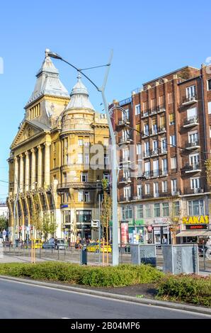 Budapest, Hungary - Nov 6, 2019: Historical buildings in the center of the Hungarian capital city on a vertical photo. Road and train station in the foreground. Eastern European cities. Stock Photo