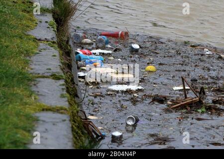 a raft of floating rubbish ( mainly food and drink packaging) in a canal Stock Photo