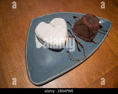 Gourmet chocolate and ice cream dessert with heart. Petit gateau dessert. Stock Photo