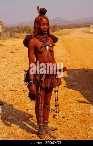 Group of women of the Himba tribe walks through the desert in national  clothes Stock Photo - Alamy