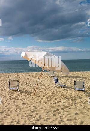 Deck chairs and a beach umbrella on the beach, Jetties Beach, Nantucket, Massachusetts, USA Stock Photo