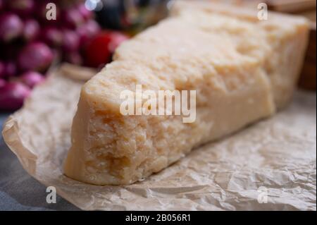 One piece of authentic Parmigiano-Reggiano or Parmesan Italian hard, granular cheese close up Stock Photo