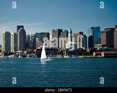 Downtown Boston with a sailboat as seen from across the harbor. Stock Photo