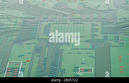 Circuit board with electronics on the back of the panel. Tracks on the board. The world of electronics. Stock Photo