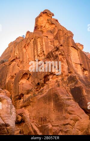 Breathtaking natural gorge called Al-Siq, carved in the red cliffs by the water flow, Petra ancient city complex and tourist attraction, Hashemite Kingdom of Jordan. Sunny winter day, cloudless sky Stock Photo