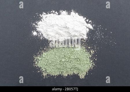 Close-up of a cosmetic dry white and green clay powder on gray background Stock Photo