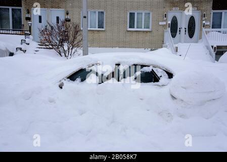 Car buried in snow after a storm, province of Quebec, Canada. Stock Photo