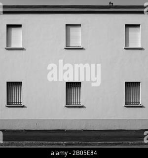 Old-fashioned factory facade with roller shutters in the southern suburbs of Milan, Italy Stock Photo