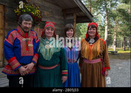 Sami family in traditional clothing near Ivalo, a village in Inari, Lapland, in northern Finland Stock Photo