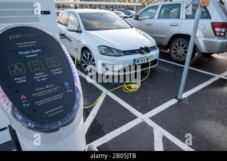 Volkswagen Golf GTE charging at the Podpoint electric charging points at Tesco Superstore Stock Photo