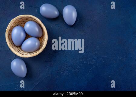 Easter composition with eggs on dark blue background Stock Photo