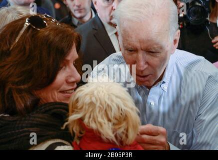 During a New Hampshire primary campaign event, former U.S. Vice President Joe Biden reacts to a woman's small dog.
