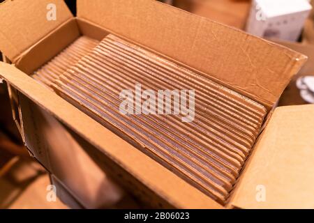 A pack of cardboard boxes under warm light Stock Photo