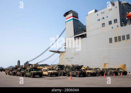 Soldiers from 3rd Battalion, 25th Aviation Regiment, and 2nd Squadron, 6th Cavalry Regiment, both assigned to 25th Combat Aviation Brigade, 25th Infantry Division and Marines from 31st Marine Expeditionary Unit prepare military equipment and vehicles Feb. 17, 2020, at Chuk Samet, Thailand. Over 700 vehicles, containers and pieces of equipment were offloaded from Maritime Sealift Command M/V Cape Hudson (T-AKR 5066) in support of exercise Cobra Gold 20 and movements aligning with U.S. Army Pacific's program, 'Pacific Pathways,' in explaining Army's engagement in the Pacific region. Stock Photo