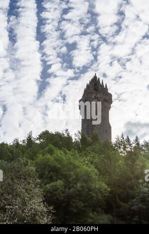 Stirling, Scotland  - September 17 2019: Close up of the tower of the Wallace Monument with broken clouds in the background, Stirling, UK September 17 Stock Photo