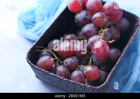 Close up of red grape in a container on table  Stock Photo