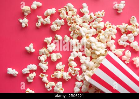top view of popcorn on red background, spilling  Stock Photo