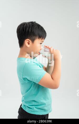 kid drinking milk on white background Stock Photo
