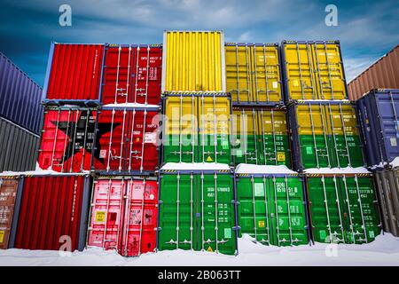 The national flag of Guinea Bissau  on a large number of metal containers for storing goods stacked in rows on top of each other. Conception of storag Stock Photo