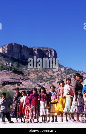 Young girl sits by her simple adobe and log home in the Tarahumara village  of San Alonso in the Copper Canyon area of Mexico Stock Photo - Alamy