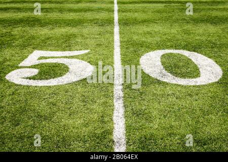 Football Field 50 Yard Line on the Grass with Artificial Turf Stock Photo