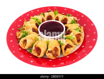 Savoury pigs in blankets with cranberry sauce dip isolated on a white background Stock Photo