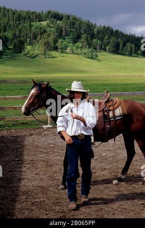 CANADA, ALBERTA, NEAR CALGARY, BAR C RANCH RESORT, HORSE STABLES, COWBOY Stock Photo