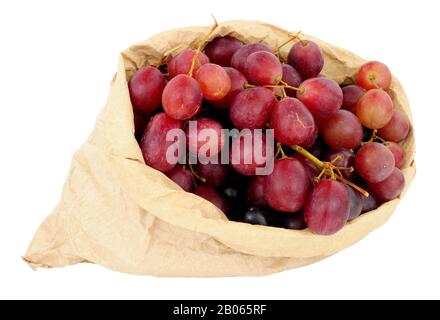 Fresh grapes in an environmentally friendly brown paper bag isolated on a white background Stock Photo
