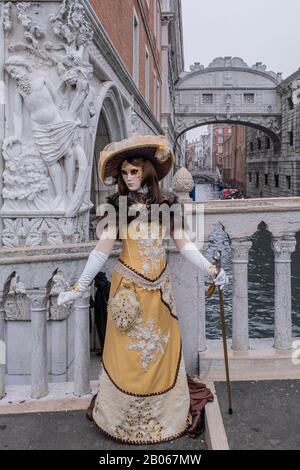 A mask poses in St. Mark's Square on February 17, 2020 in Venice, Italy. The theme for the 2020 edition of Venice Carnival is ‘Game, Love & Folly' Stock Photo