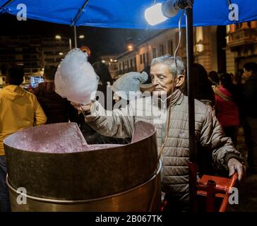 Man makes cotton candy for sale at a festival Stock Photo