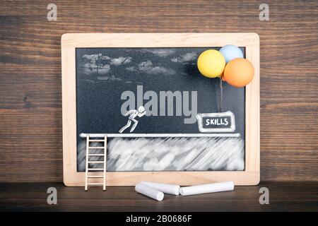 Skills concept. Instalation with stairs, white human figure and balloons on blackboard. Illustration for education, learning, growth, cereer, idea and ambition. Stock Photo