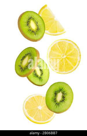 Slices falling kiwi and lemon isolated on white background. Stock Photo