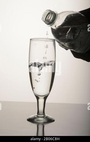 Pouring water in glass, Glassware, Dropping, Wine Stock Photo