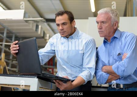 portrait of two warehouse workers doing inventory Stock Photo
