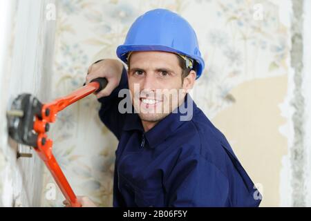 a worker uses scissors indoors Stock Photo