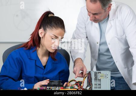 tech tests electronic equipment in service centre Stock Photo