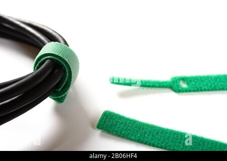 green velcro cable tie and cable on white Stock Photo