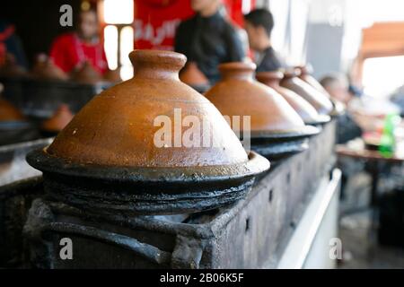 Delicious moroccan tajine prepared and served in clay pots, Marrakech, Morocco Stock Photo