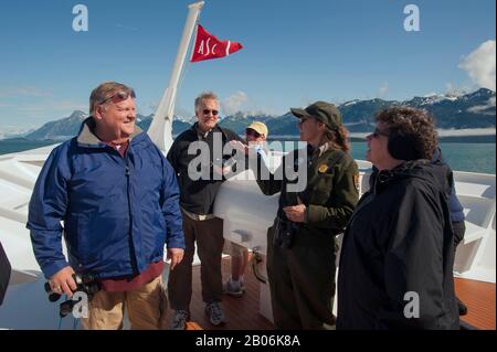 Passengers on cruise ship Safari Endeavour in Glacier Bay National Park, Alaska talking to park ranger Stock Photo