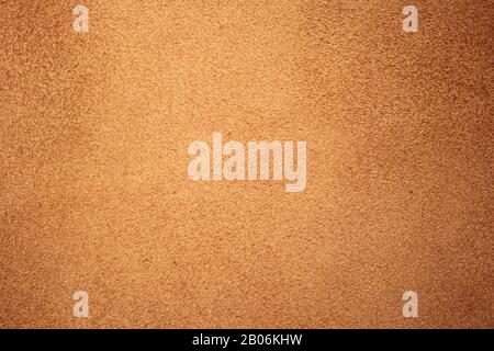 Chamois texture, light brown suede. Shabby leather background, natural skin pattern. Rough fabric surface Stock Photo