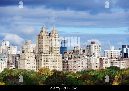 View over the autumnal Central Park to the Dakota Towers, Manhattan, New York City, New York State, USA Stock Photo