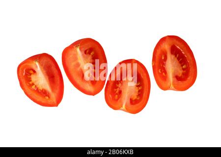 slices plum tomatoes on white background with natural shadow. Top view. Stock Photo