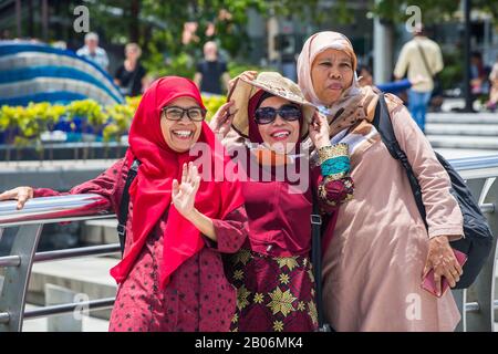 Multiple generations of muslim women taking a group photo together in Singapore. Stock Photo