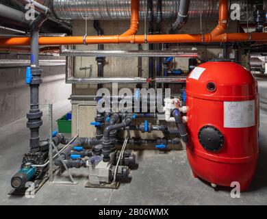 Interior of modern boiler room. Piping system. Red boiler unit. Stock Photo