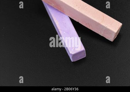 Set of colored chalks over a black background Stock Photo
