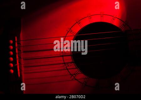Music concept - Red toned abstract of a Japanese Kimbara acoustic guitar. Copyspace Stock Photo