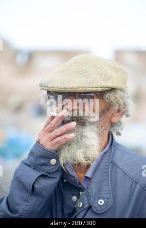 Essaouira, Morocco - 17 February 2019 Man with beard smoking cigarette Stock Photo