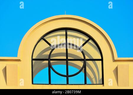 Curved roof structure with metal grill isolated against blue sky in close up view Stock Photo