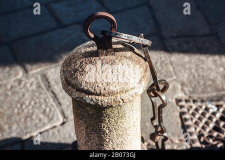 decorative pillar and chains on the street Stock Photo
