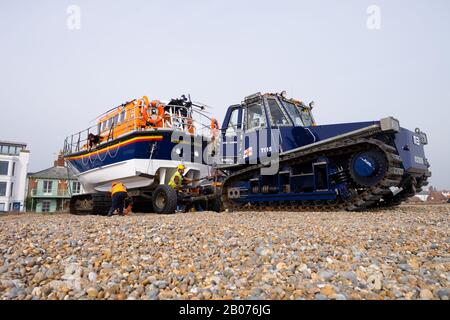 Tractor towing the Aldeburgh lifeboat on the beach ready for launching. Aldeburgh beach, Aldeburgh, Suffolk. UK Stock Photo